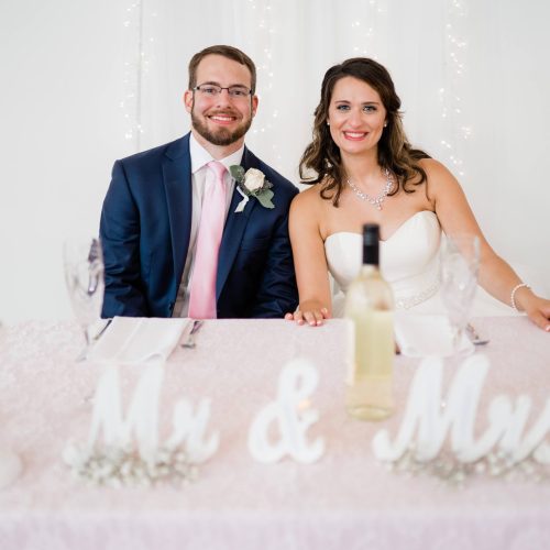 A young couple pose together in their wedding pictures, the bride showing off radiant skin complemented by quality beauty products. Whole Life Beauty uses only the best products to achieve the perfect look for any occasion!